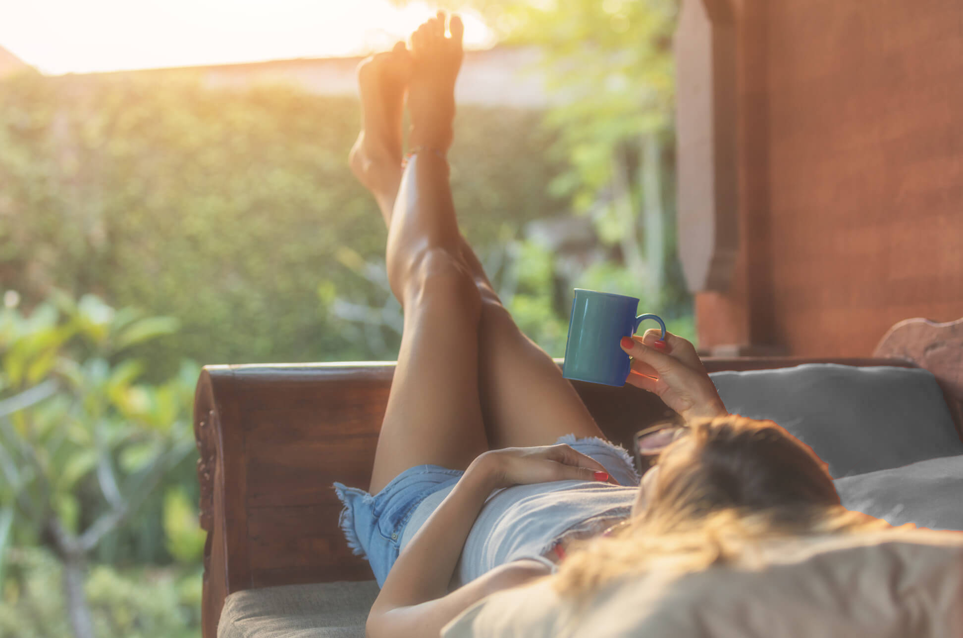 Woman Laying Down Holding Coffee Mug