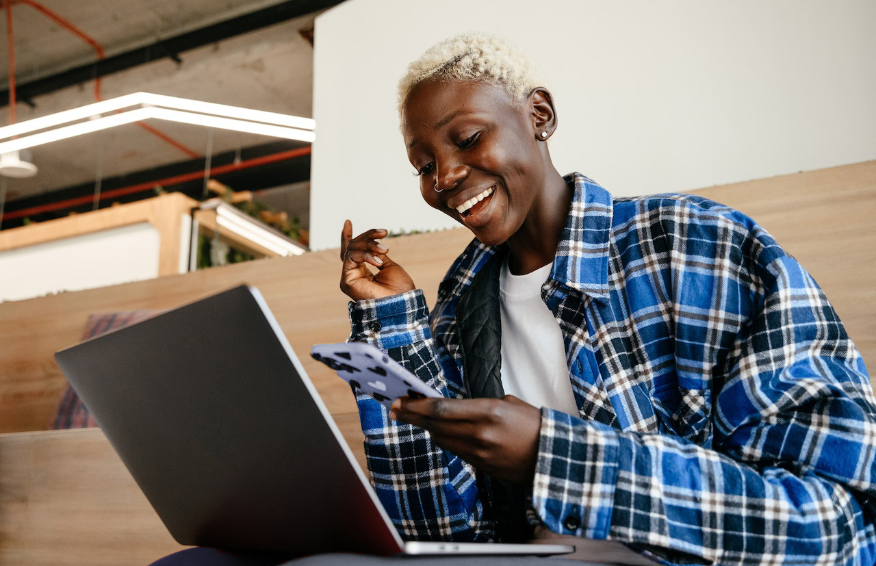 woman on cell and laptop
