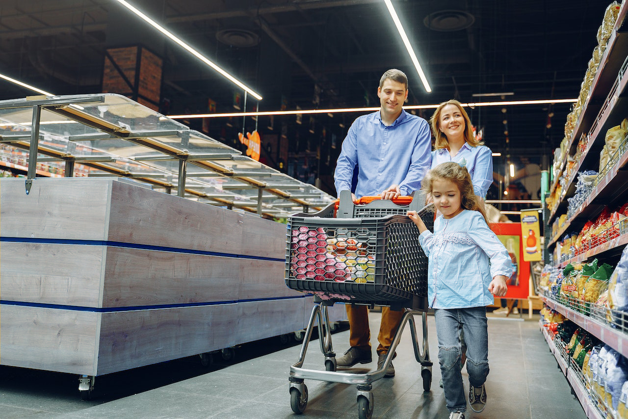 Parents Grocery Shopping with Young Daughter 