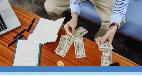 person sitting on couch counting money