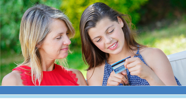 Mother explaining credit card use with daughter