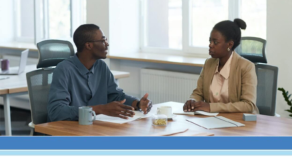 man and woman looking over documents