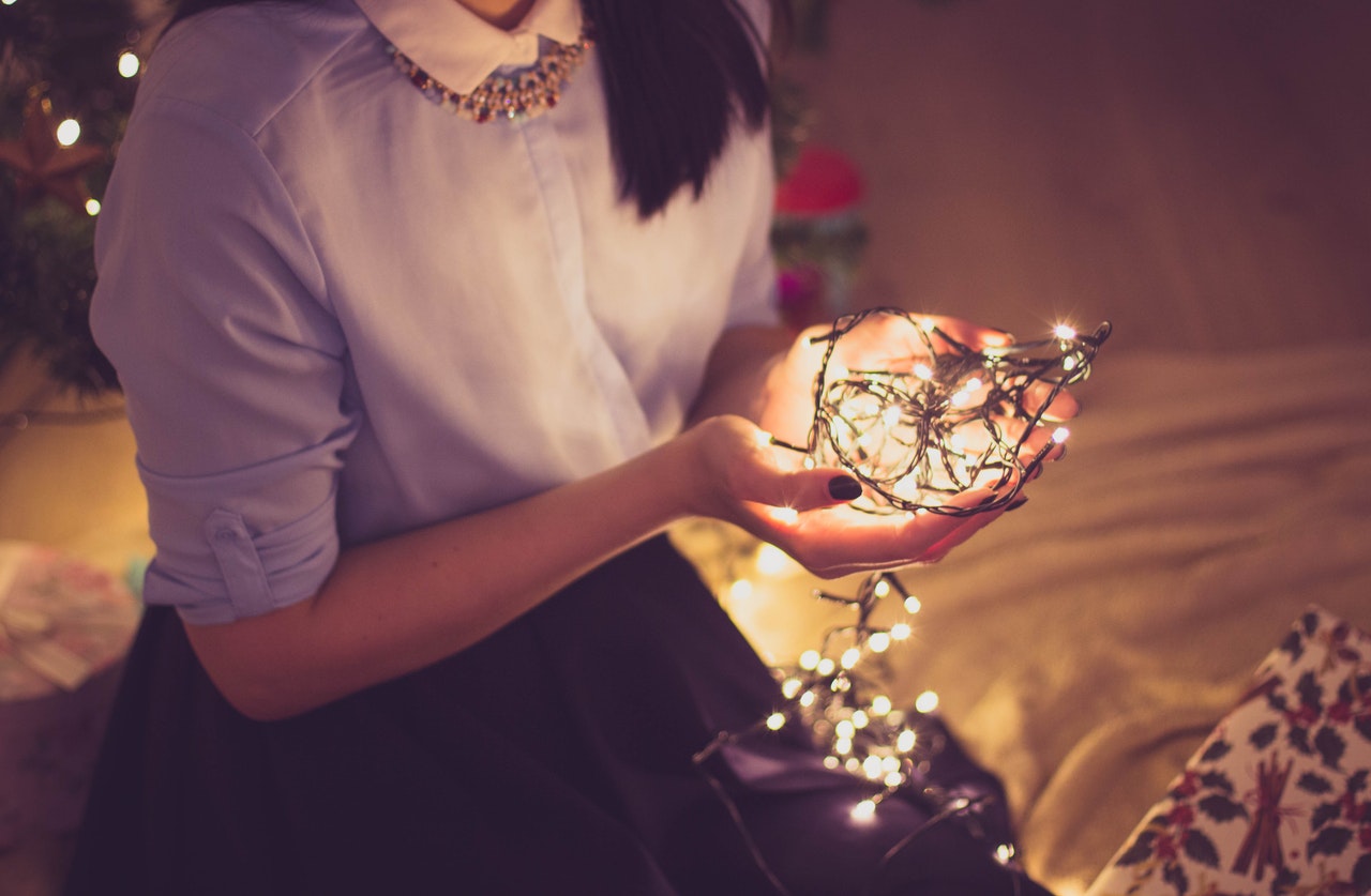 Women Holding String of Lights