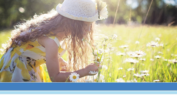 girl smelling wild flowers