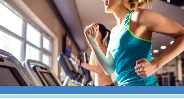 two fit women running on treadmill