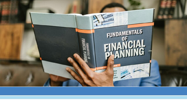 man reading book titled Financial Planning